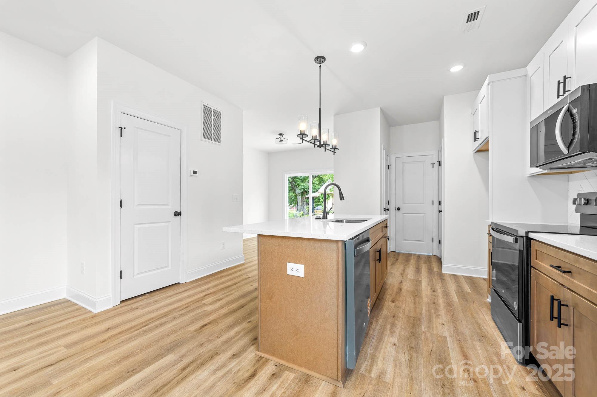 424 Airline Extension Shelby, NC 28150 - Photo 8 of 35 a view of a kitchen with kitchen island white cabinets and wooden floor