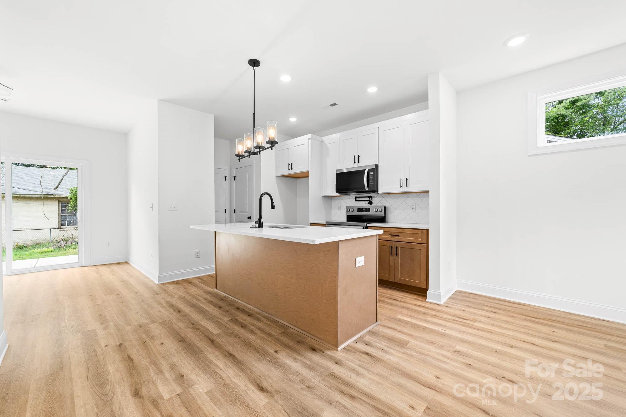 424 Airline Extension Shelby, NC 28150 - Photo 10 of 35 a kitchen with kitchen island a sink a stove and a refrigerator