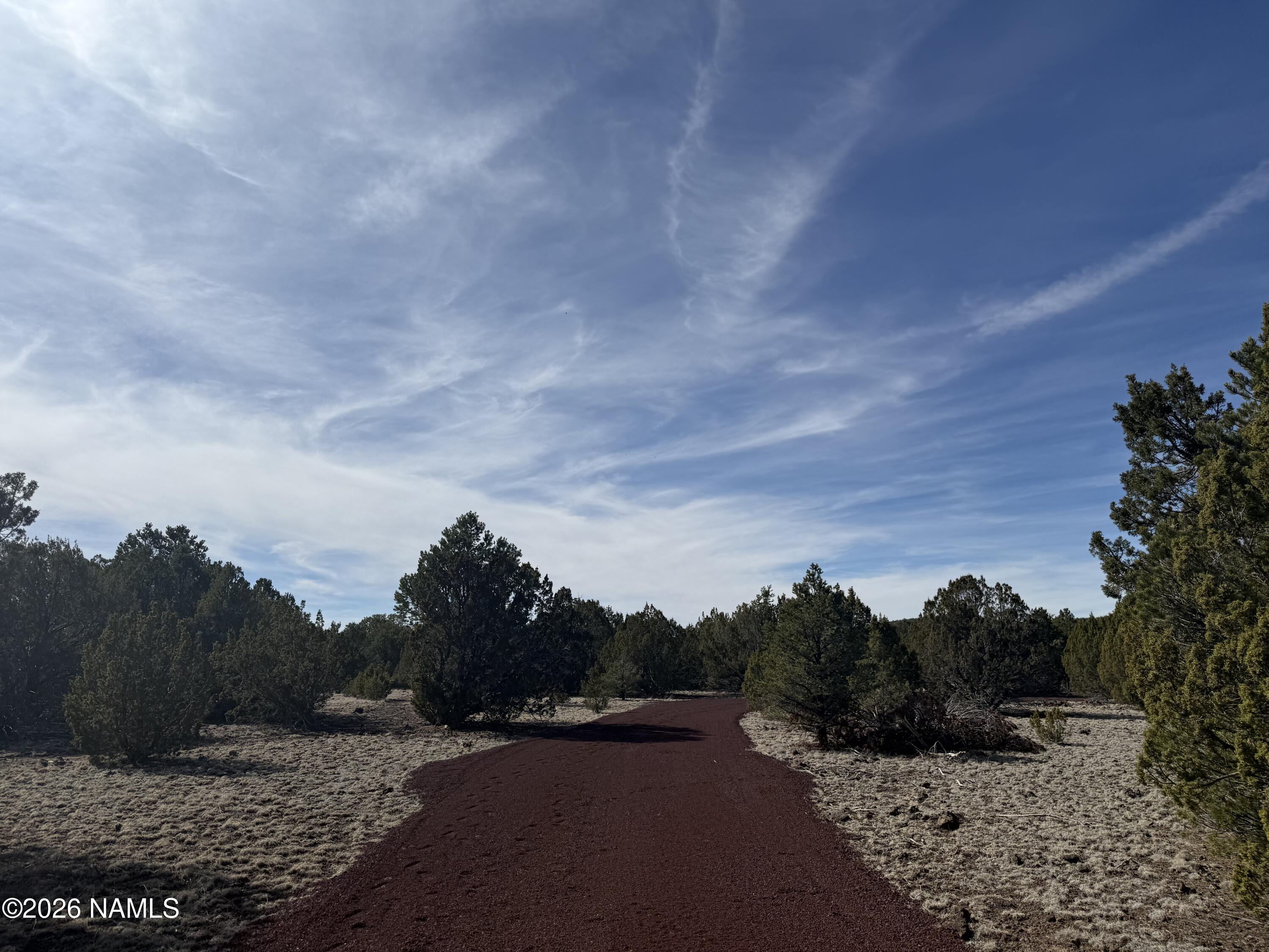 5892 North Santa Fe Road Williams, AZ 86046 - Photo 5 of 33 a view of a dry yard with wooden fence