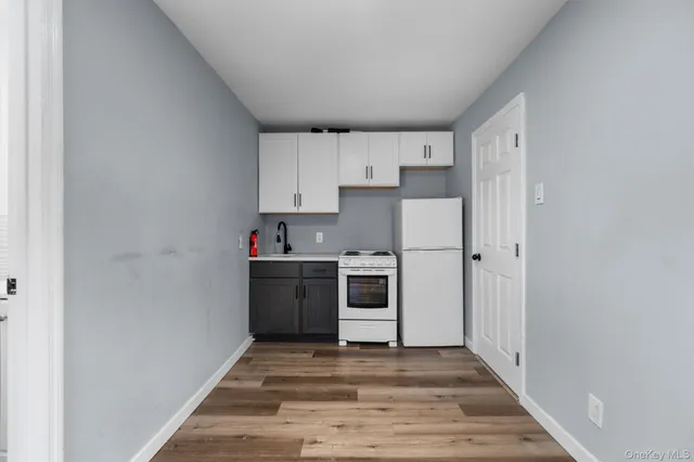 a kitchen with a refrigerator sink and cabinets