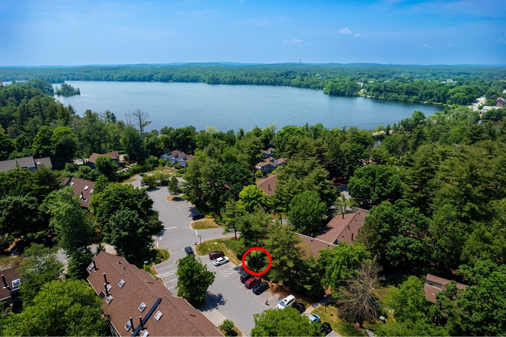 244 Old Beaverbrook, Unit 244 Acton, MA 01718 - Photo 1 of 42 an aerial view of lake and residential houses with outdoor space and trees