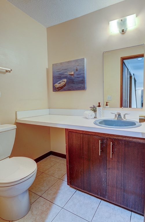 244 Old Beaverbrook, Unit 244 Acton, MA 01718 - Photo 16 of 42 a bathroom with a sink a toilet and mirror