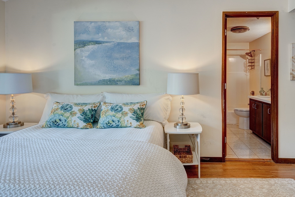 244 Old Beaverbrook, Unit 244 Acton, MA 01718 - Photo 21 of 42 a bedroom with a bed and a lamp