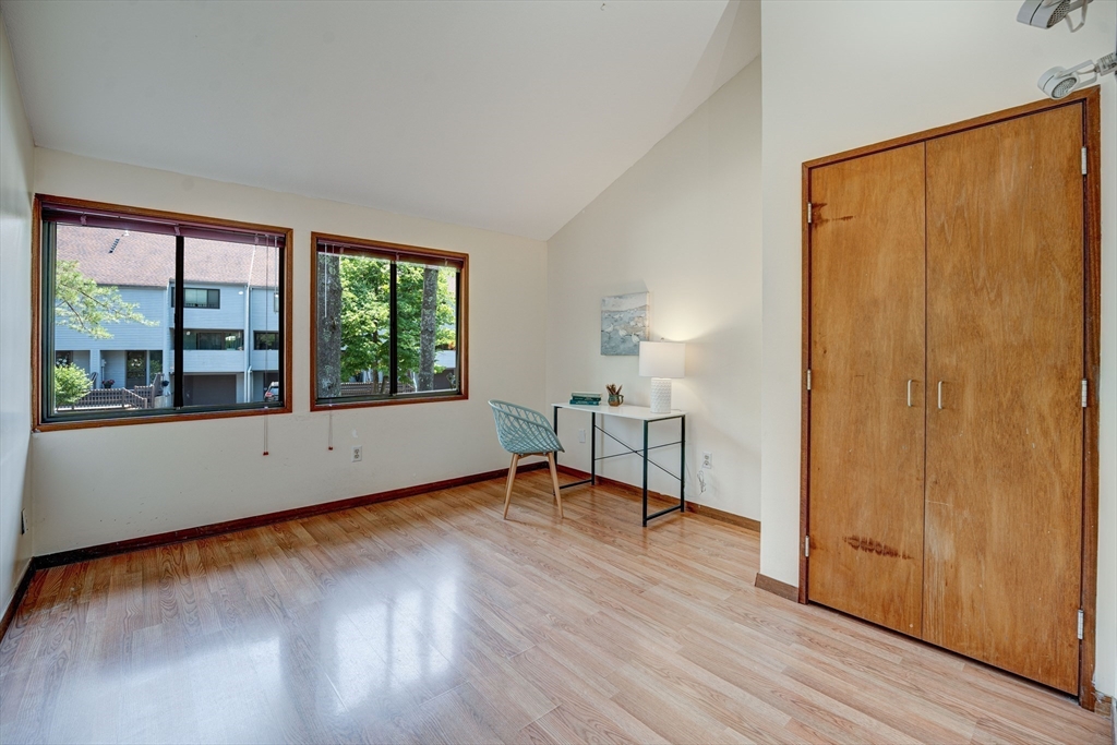 244 Old Beaverbrook, Unit 244 Acton, MA 01718 - Photo 24 of 42 a view of an empty room with wooden floor and a window