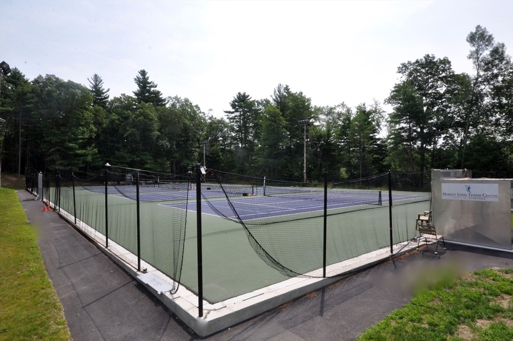 244 Old Beaverbrook, Unit 244 Acton, MA 01718 - Photo 35 of 42 a view of a balcony with tennis net