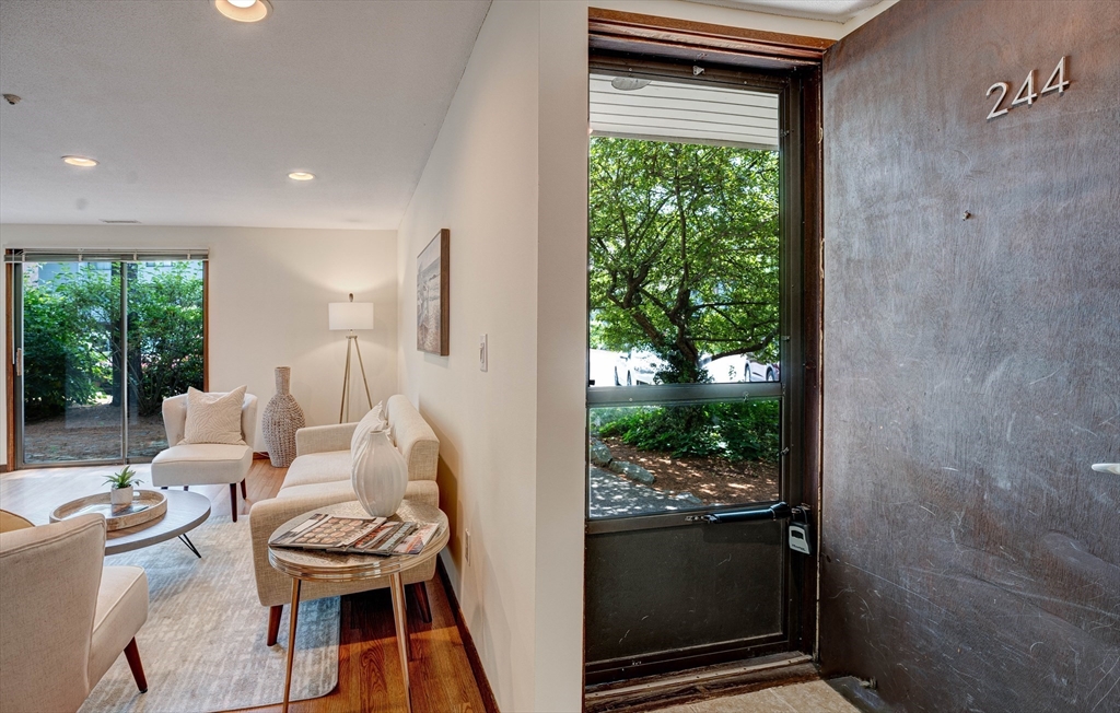 244 Old Beaverbrook, Unit 244 Acton, MA 01718 - Photo 7 of 42 a living room with furniture a window and a fireplace