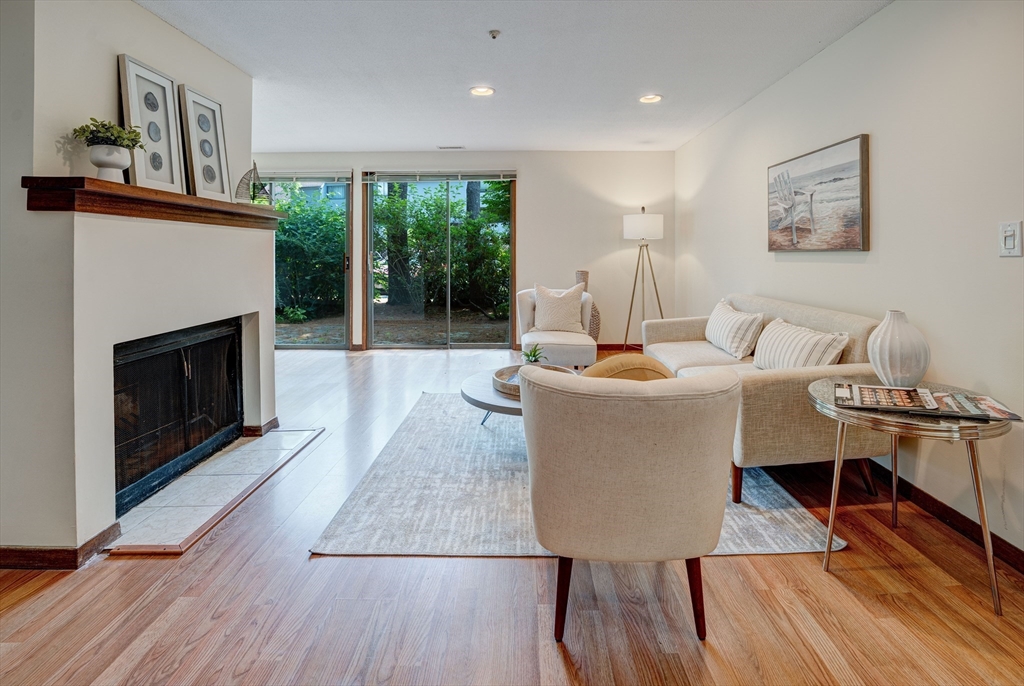 244 Old Beaverbrook, Unit 244 Acton, MA 01718 - Photo 8 of 42 a living room with furniture and a fireplace