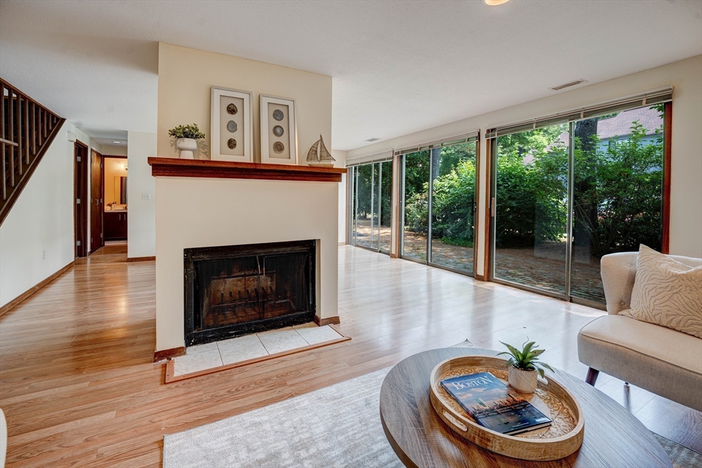 244 Old Beaverbrook, Unit 244 Acton, MA 01718 - Photo 9 of 42 a living room with furniture and a fireplace