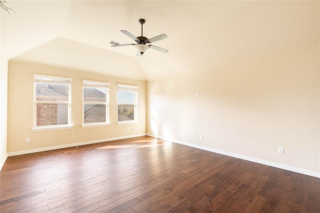 9101 Waters Lane Rowlett, TX 75089 - Photo 29 of 34 a view of an empty room with wooden floor and a window