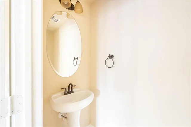 a bathroom with a sink a mirror and vanity