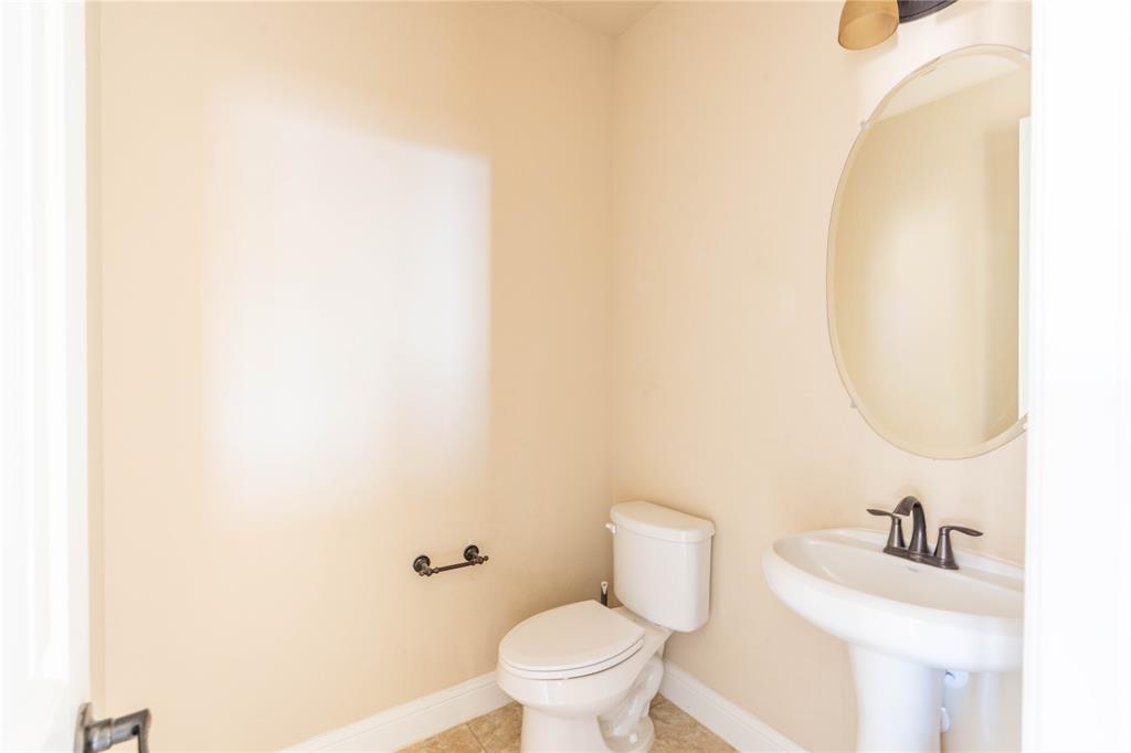 9101 Waters Lane Rowlett, TX 75089 - Photo 31 of 34 a bathroom with a sink and a toilet