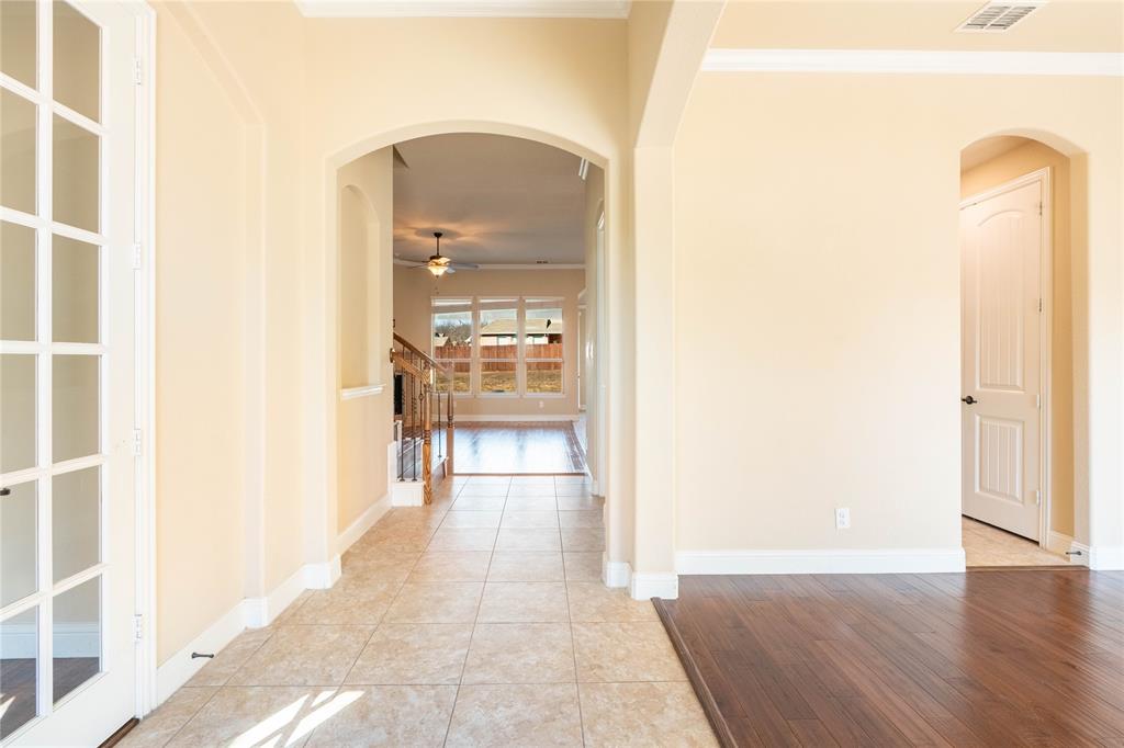 9101 Waters Lane Rowlett, TX 75089 - Photo 7 of 34 a view of a hallway with wooden floor and a bathroom