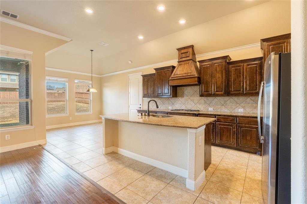 9101 Waters Lane Rowlett, TX 75089 - Photo 10 of 34 a kitchen with stainless steel appliances granite countertop a sink and stove