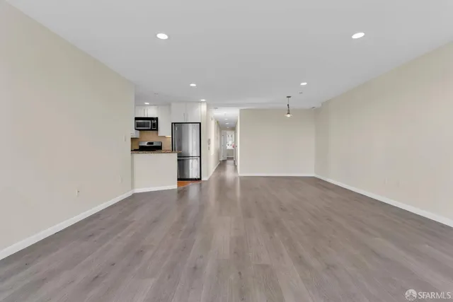 a view of a kitchen with a sink and a refrigerator