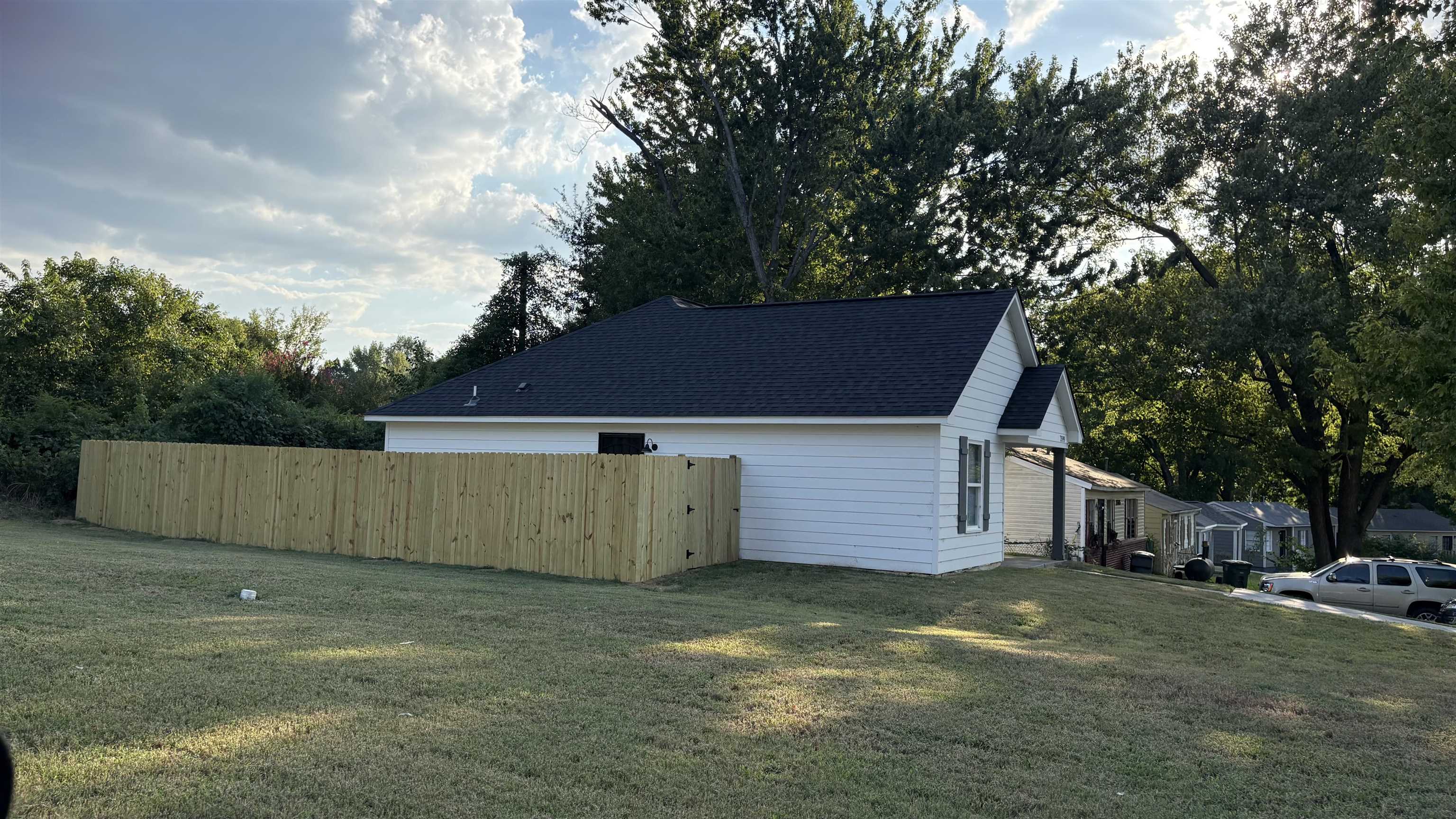 2599 Callie Road Memphis, TN 38127 - Photo 2 of 9 White siding exterior with a dark shingle roof