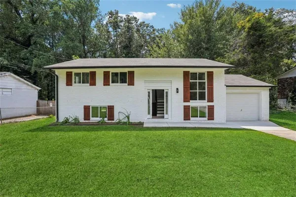 a front view of a house with a garden