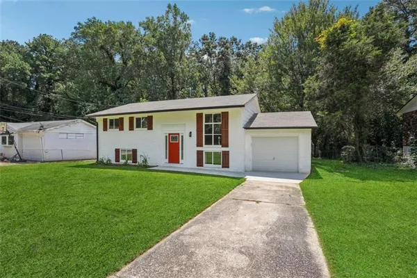 a view of a back yard with green space and porch
