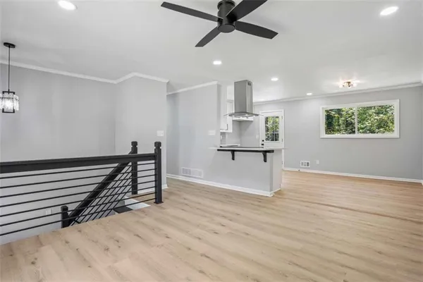 a view of a room with wooden floor and stairs