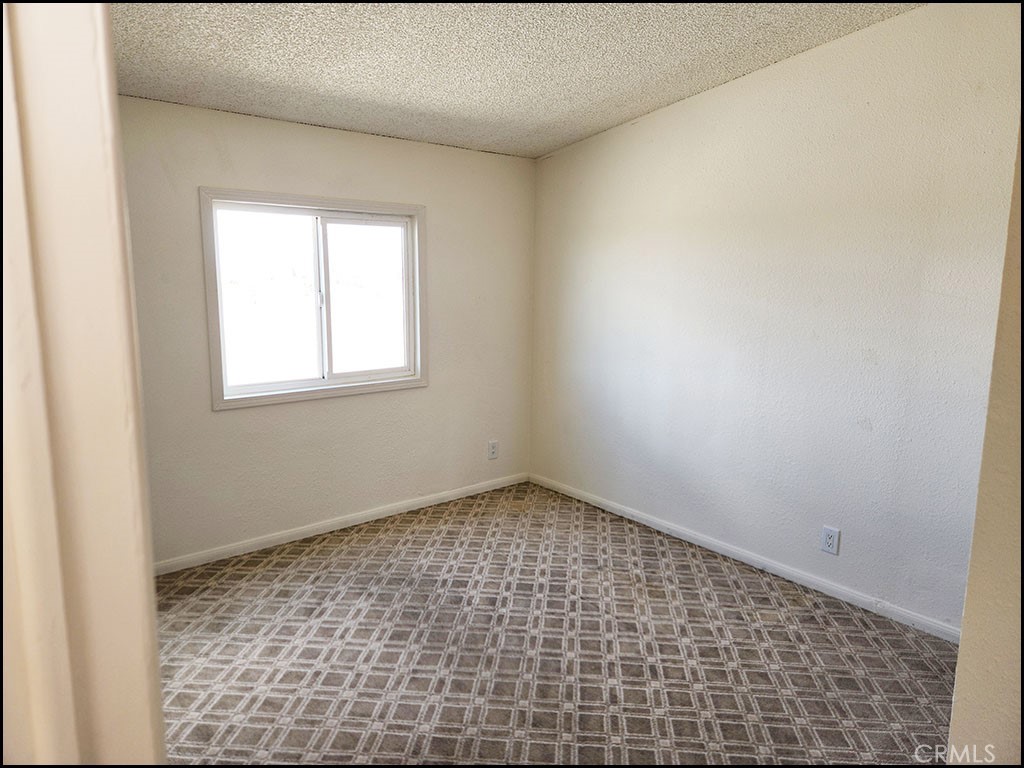 12232 Sheep Creek Road Phelan, CA 92371 - Photo 12 of 45 an empty room with a window