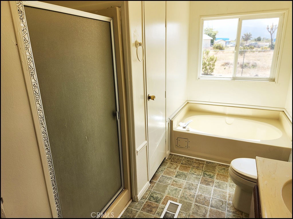 12232 Sheep Creek Road Phelan, CA 92371 - Photo 30 of 45 a bathroom with a toilet and a shower