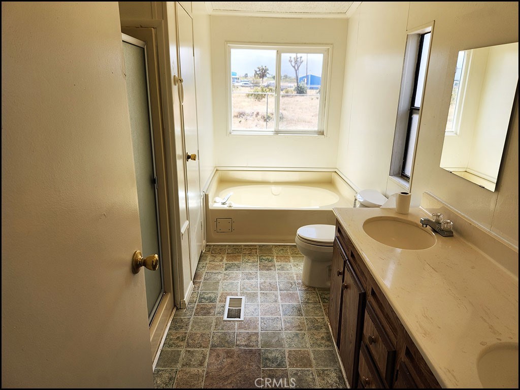 12232 Sheep Creek Road Phelan, CA 92371 - Photo 31 of 45 a bathroom with a tub sink and mirror