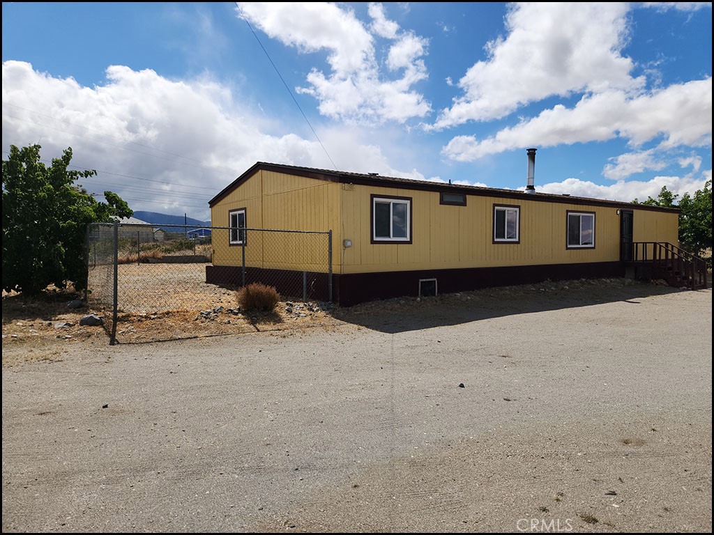 12232 Sheep Creek Road Phelan, CA 92371 - Photo 35 of 45 a front view of a house with a yard covered with snow