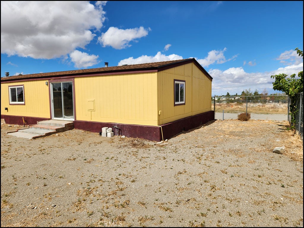 12232 Sheep Creek Road Phelan, CA 92371 - Photo 41 of 45 a view of a backyard with a large tree