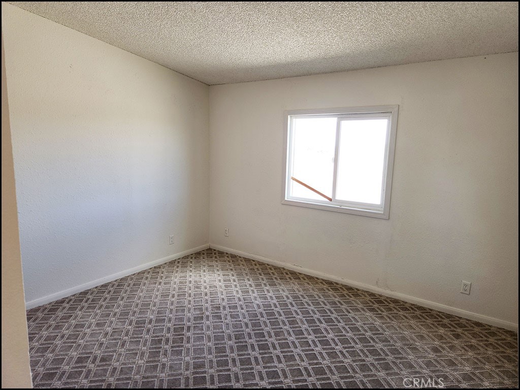 12232 Sheep Creek Road Phelan, CA 92371 - Photo 10 of 45 an empty room with a window