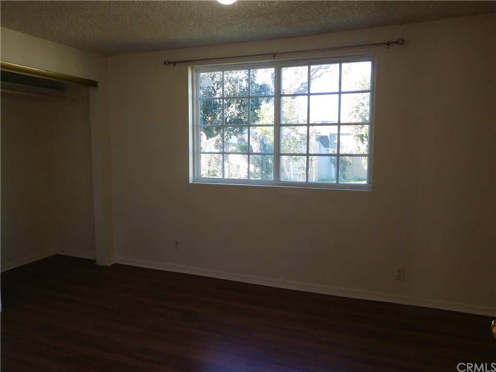15022 McRae Avenue Norwalk, CA 90650 - Photo 13 of 28 a view of an empty room with wooden floor and a window