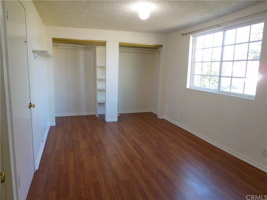 15022 McRae Avenue Norwalk, CA 90650 - Photo 14 of 28 an empty room with wooden floor and windows
