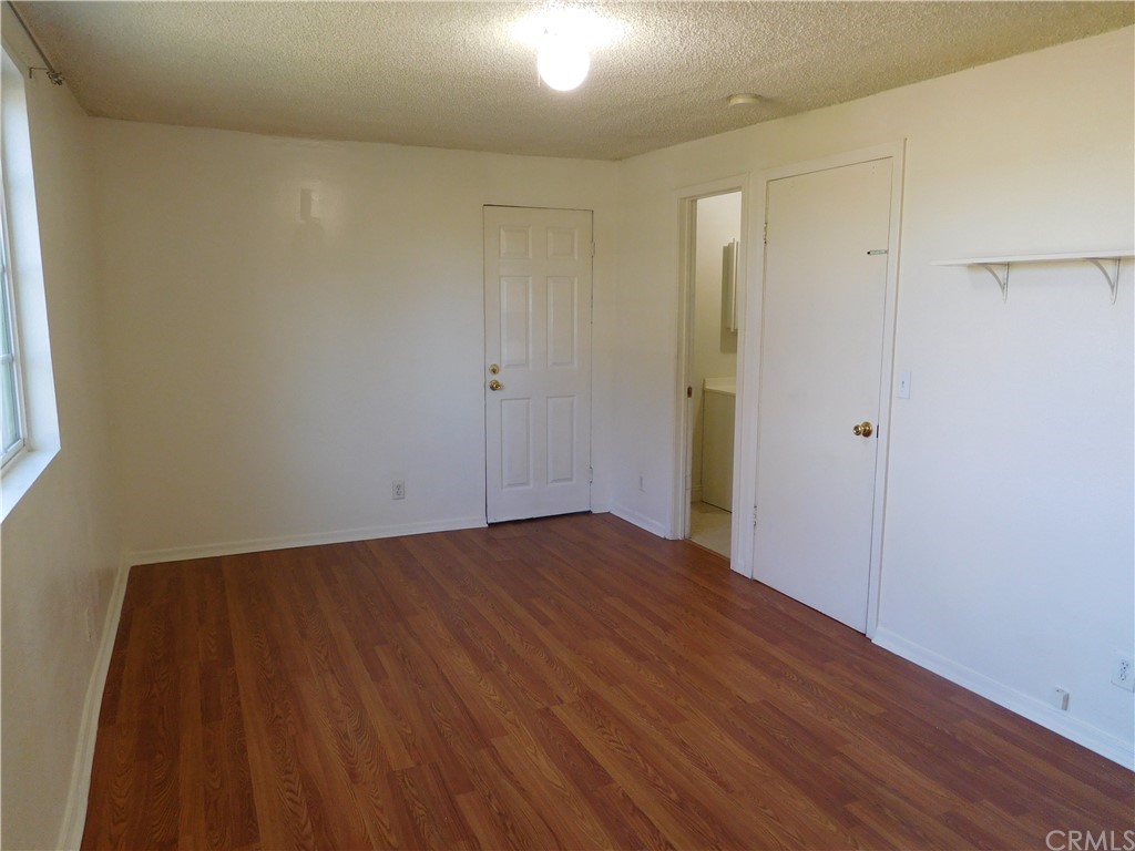 15022 McRae Avenue Norwalk, CA 90650 - Photo 15 of 28 a view of an empty room with wooden floor