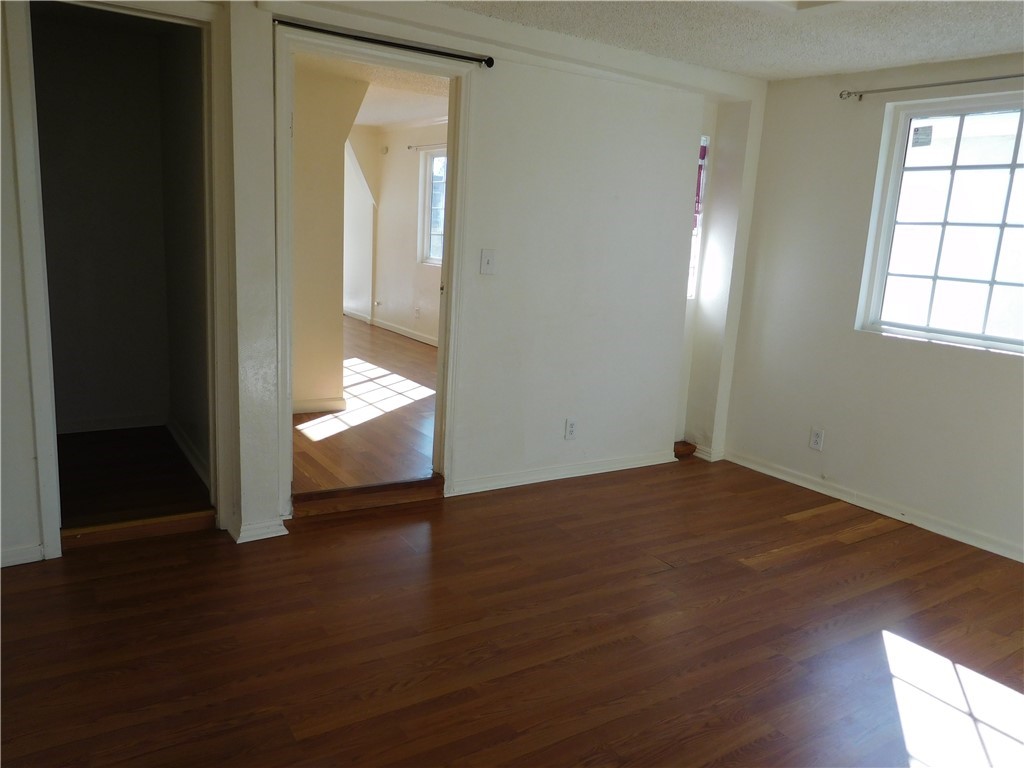 15022 McRae Avenue Norwalk, CA 90650 - Photo 16 of 28 an empty room with wooden floor and windows