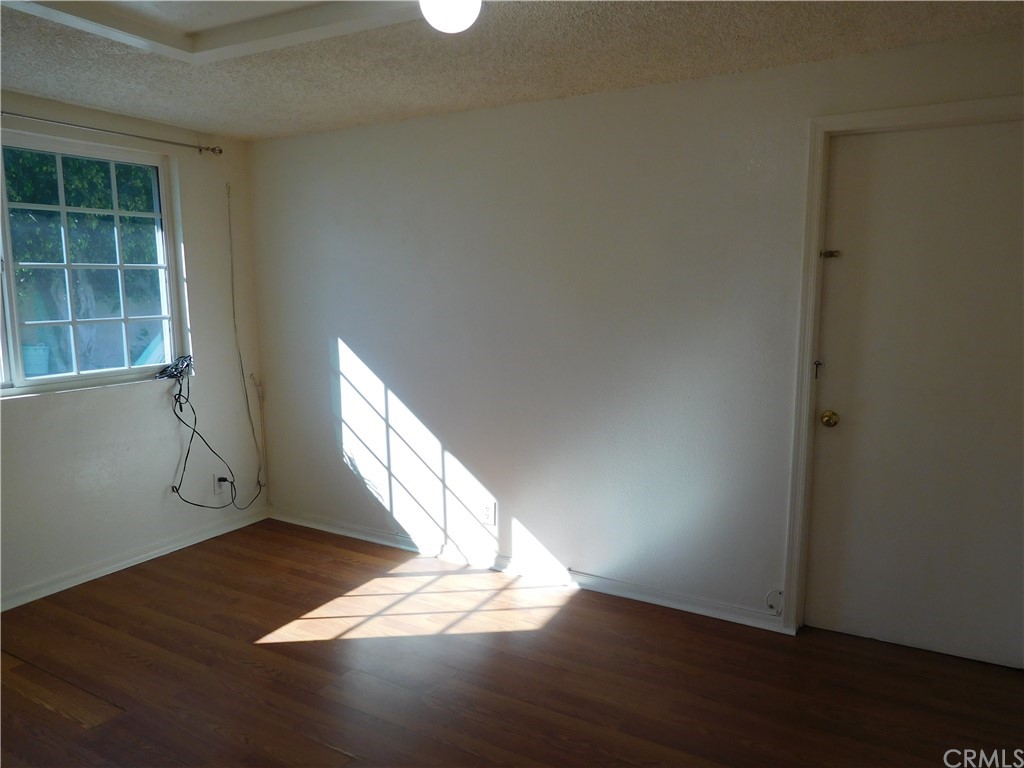 15022 McRae Avenue Norwalk, CA 90650 - Photo 18 of 28 an empty room with wooden floor and windows