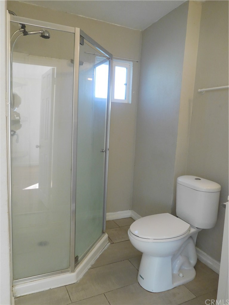 15022 McRae Avenue Norwalk, CA 90650 - Photo 25 of 28 a white toilet sitting next to a bathroom sink