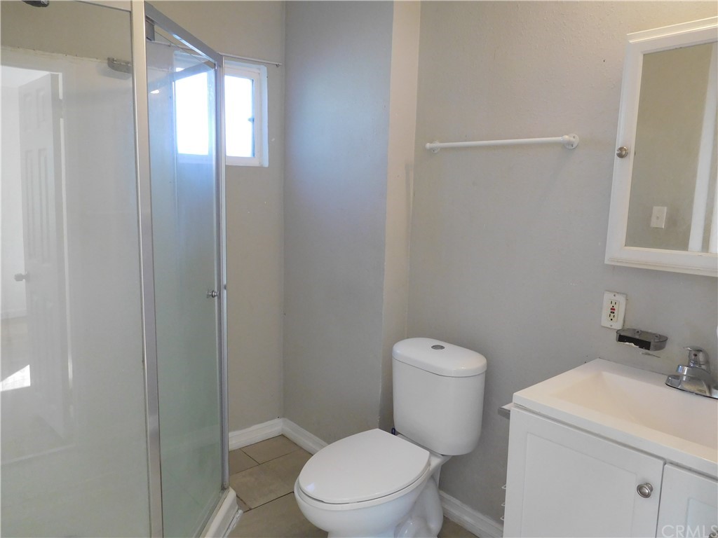 15022 McRae Avenue Norwalk, CA 90650 - Photo 28 of 28 a white toilet sitting next to a bathroom sink