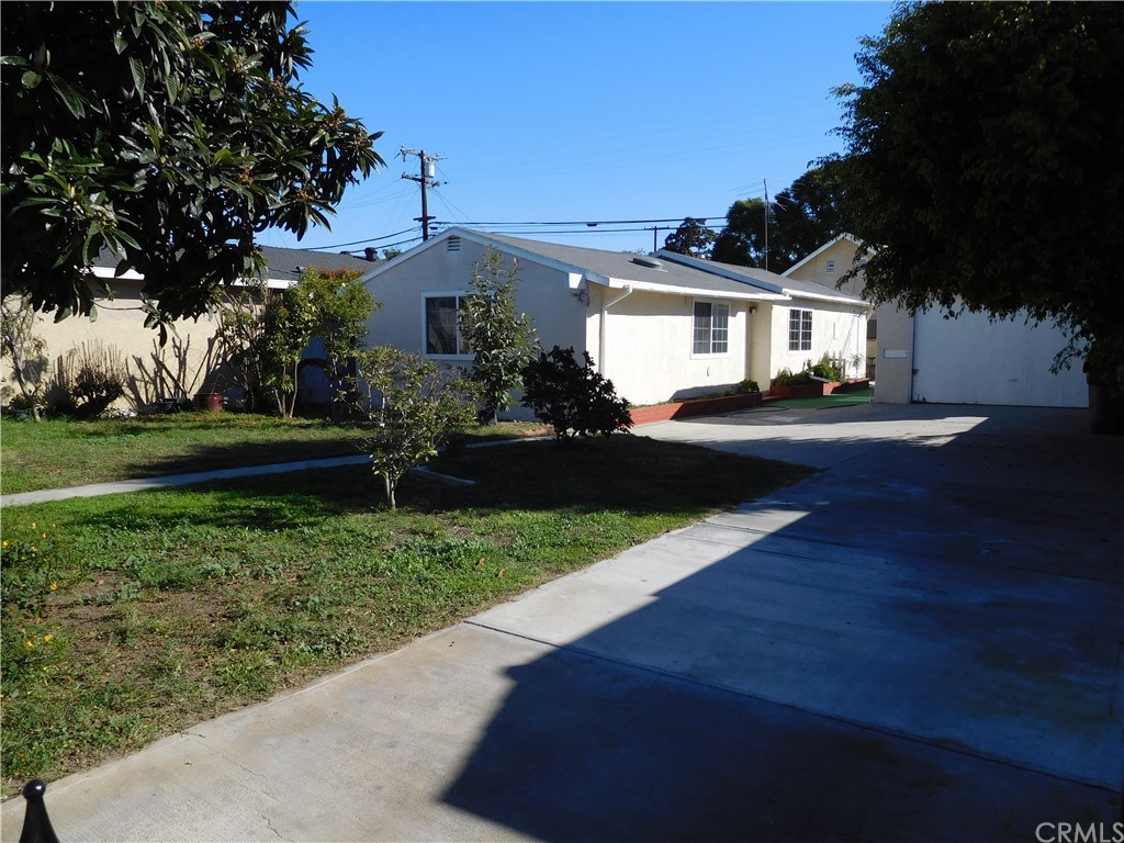 15022 McRae Avenue Norwalk, CA 90650 - Photo 5 of 28 a front view of a house with a yard and garage