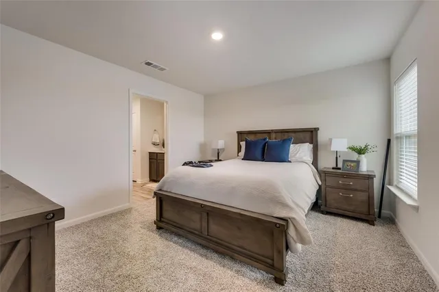 a bedroom with a bed and a lamp