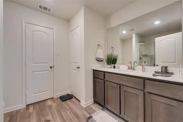 a bathroom with a double vanity sink and mirror
