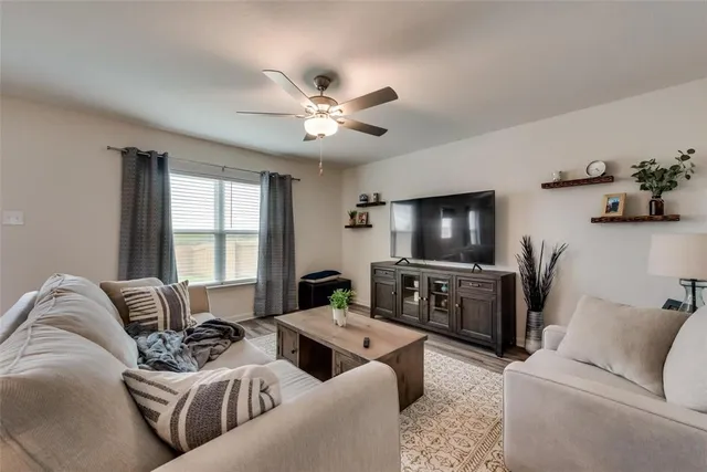 a living room with furniture and a flat screen tv