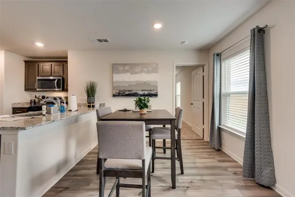 a dining room with furniture and window