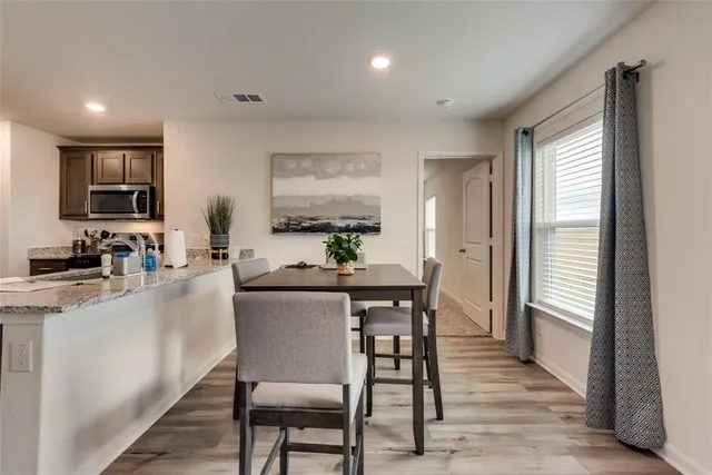 a dining room with furniture and window