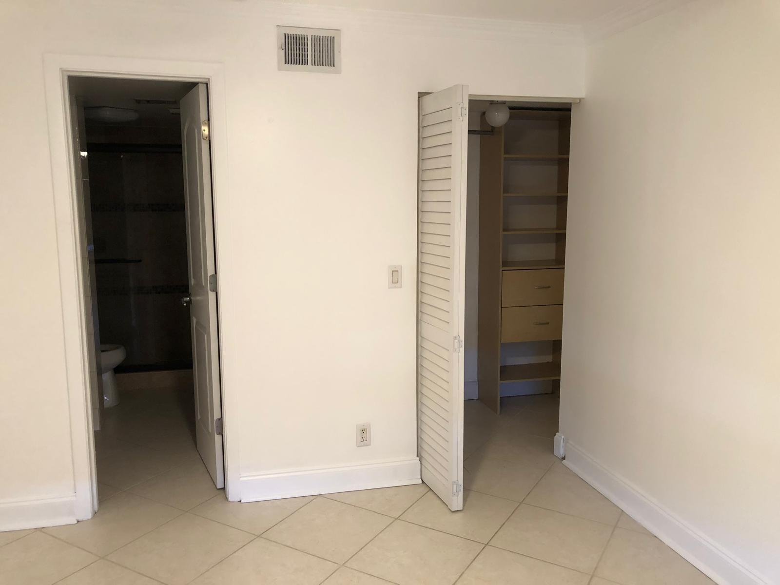 21911 Lake Forest Circle, Unit 204 Boca Raton, FL 33433 - Photo 12 of 16 an empty room with closet and a bathroom