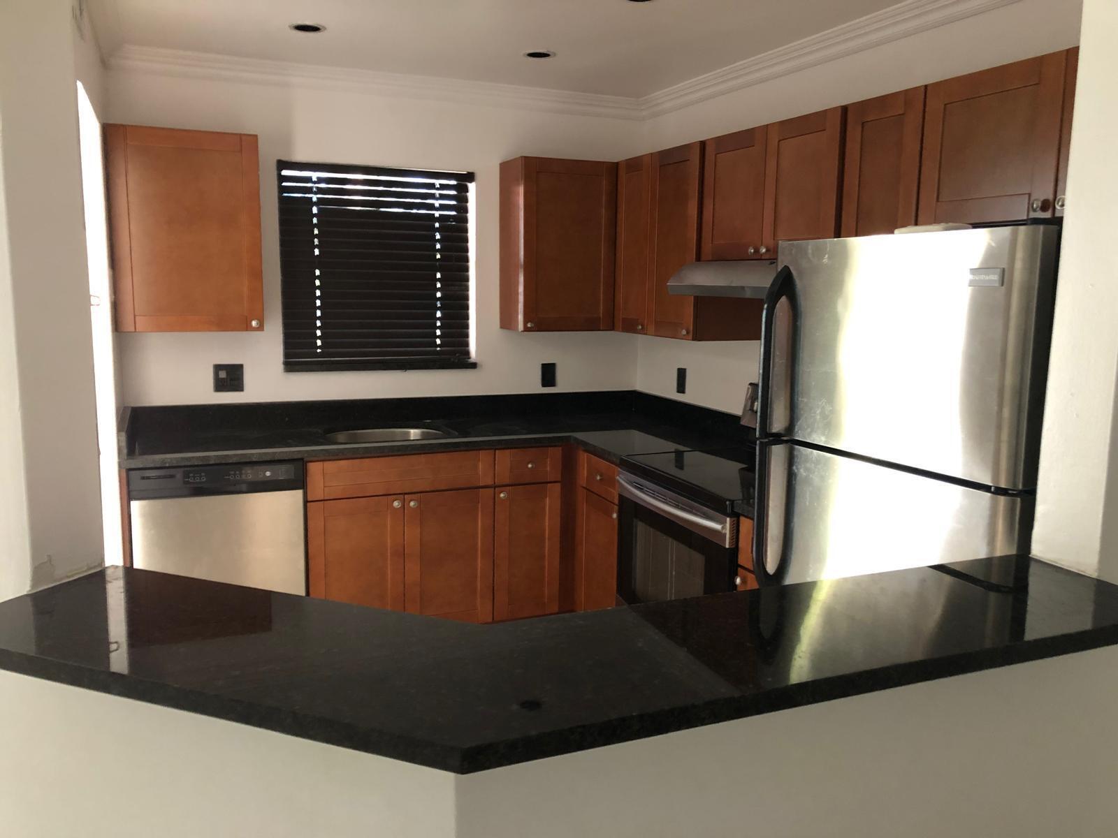 21911 Lake Forest Circle, Unit 204 Boca Raton, FL 33433 - Photo 2 of 16 a kitchen with a sink a refrigerator and cabinets