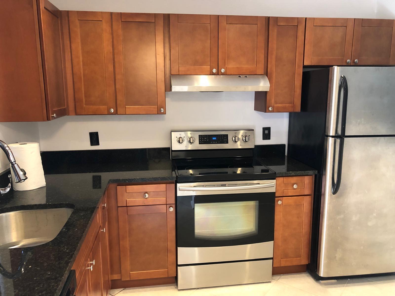 21911 Lake Forest Circle, Unit 204 Boca Raton, FL 33433 - Photo 3 of 16 a kitchen with stainless steel appliances granite countertop a refrigerator stove and cabinets
