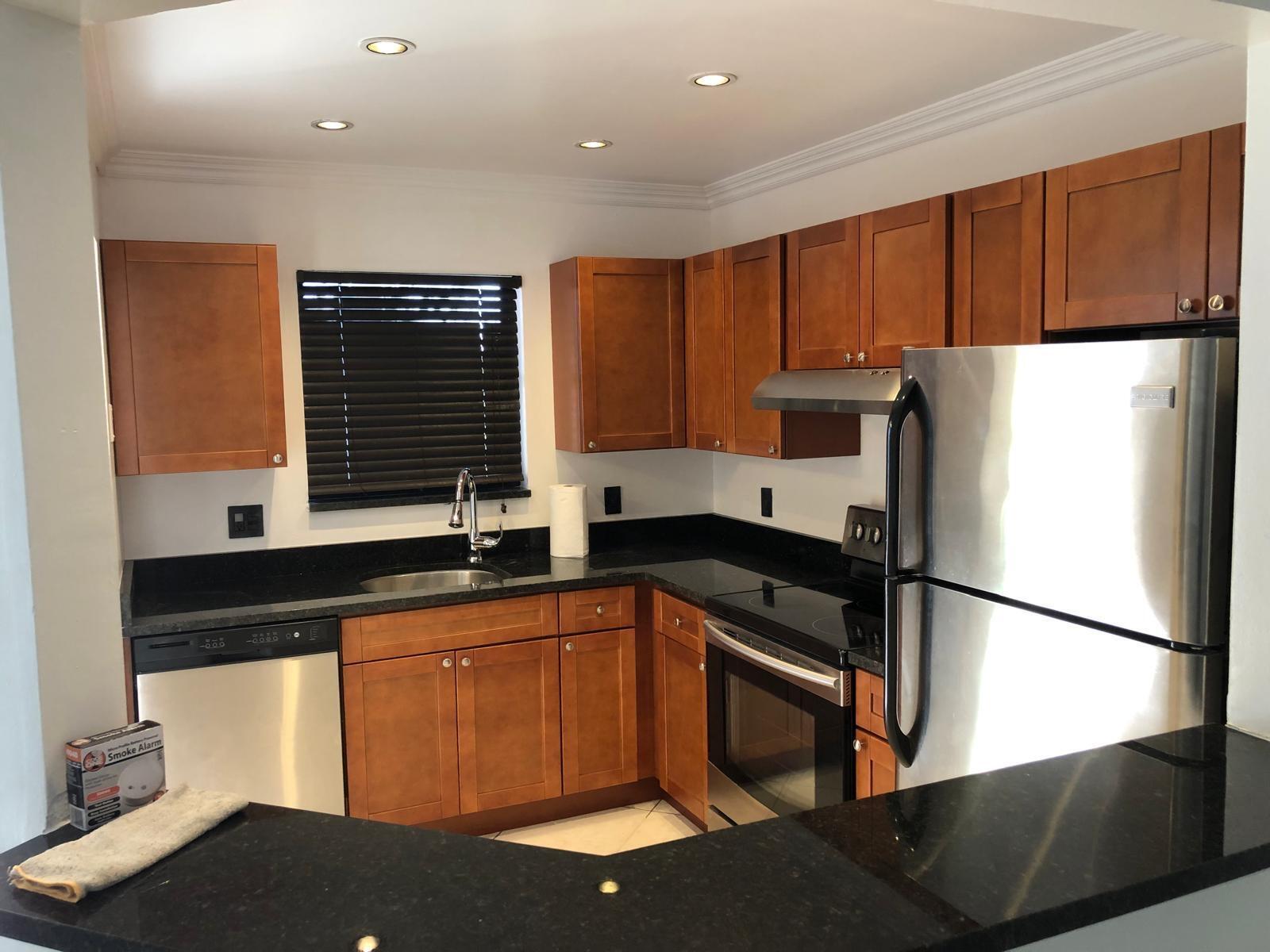 21911 Lake Forest Circle, Unit 204 Boca Raton, FL 33433 - Photo 4 of 16 a kitchen with stainless steel appliances granite countertop a refrigerator sink and cabinets