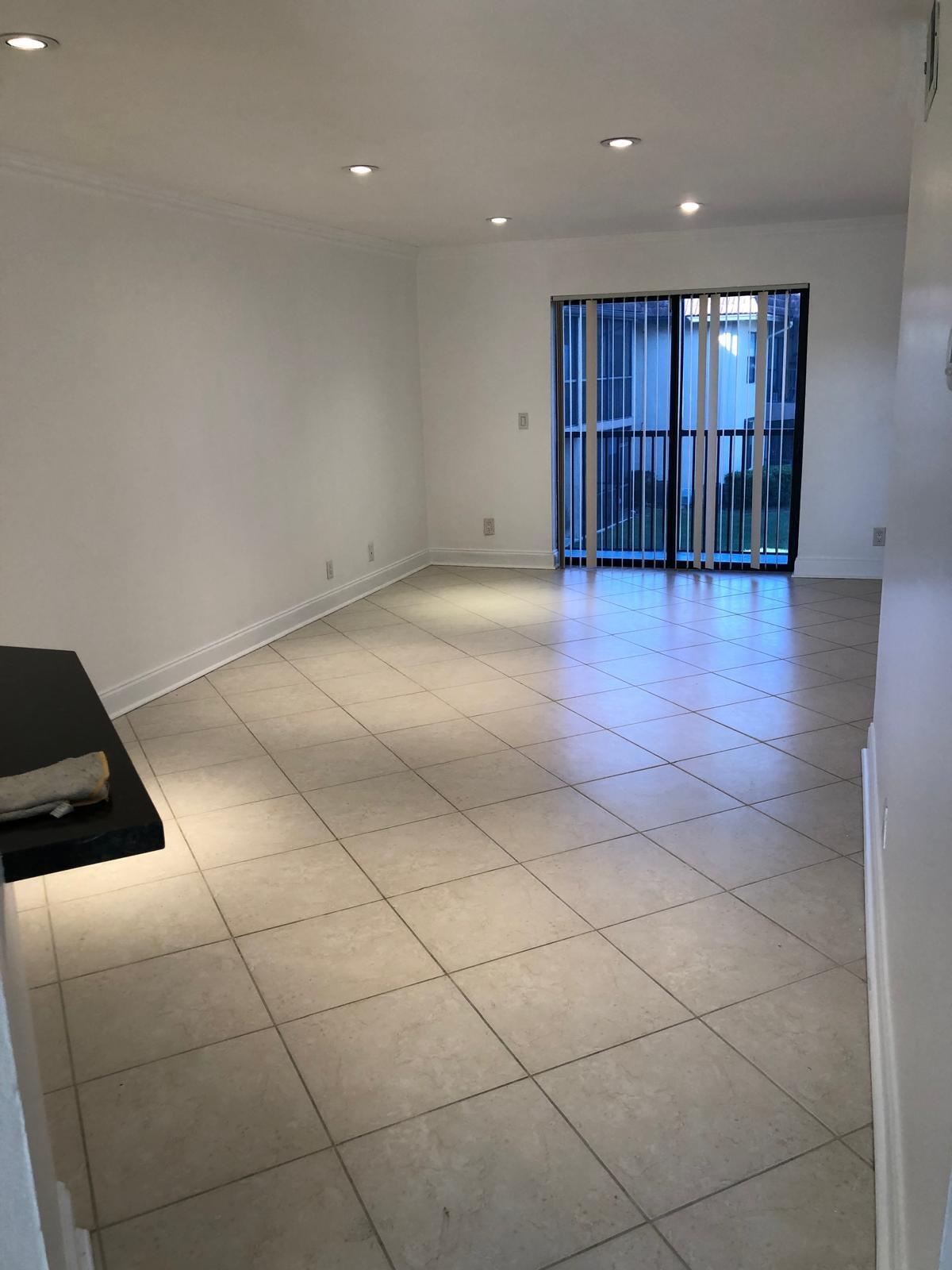 21911 Lake Forest Circle, Unit 204 Boca Raton, FL 33433 - Photo 5 of 16 a view of an empty room with wooden floor and windows