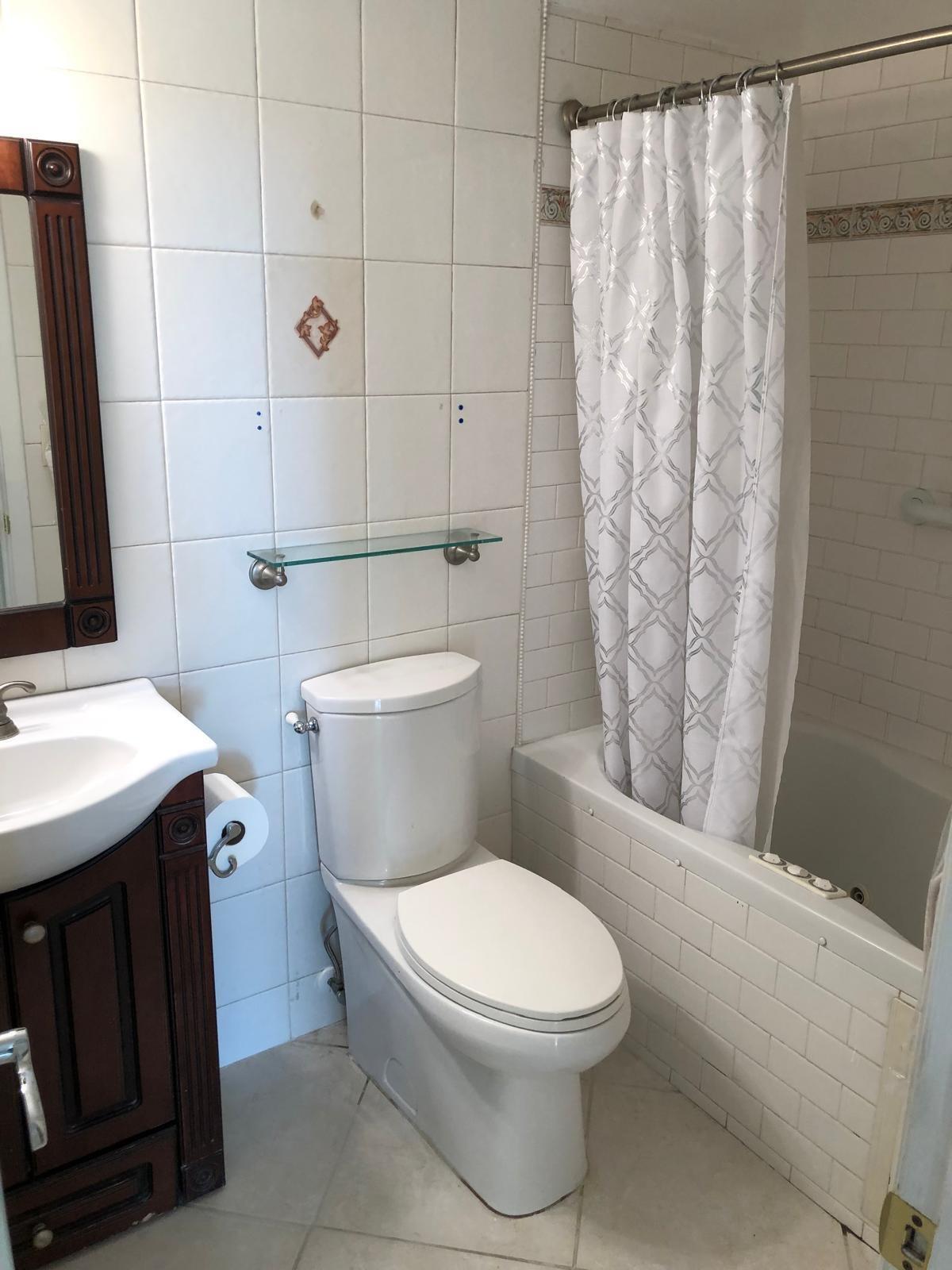 21911 Lake Forest Circle, Unit 204 Boca Raton, FL 33433 - Photo 7 of 16 a white toilet sitting next to a bathroom sink