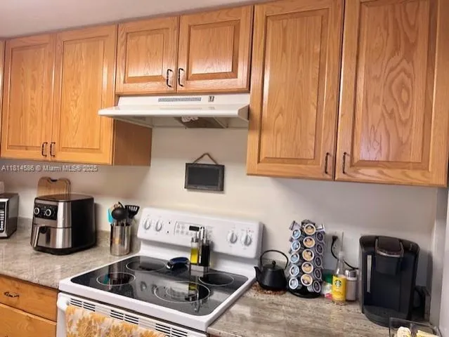 a kitchen with stainless steel appliances granite countertop a sink and cabinets