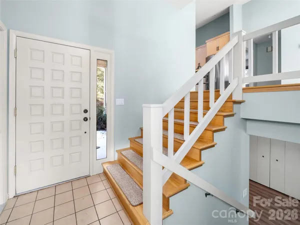 a view of entryway with wooden floor and stairs