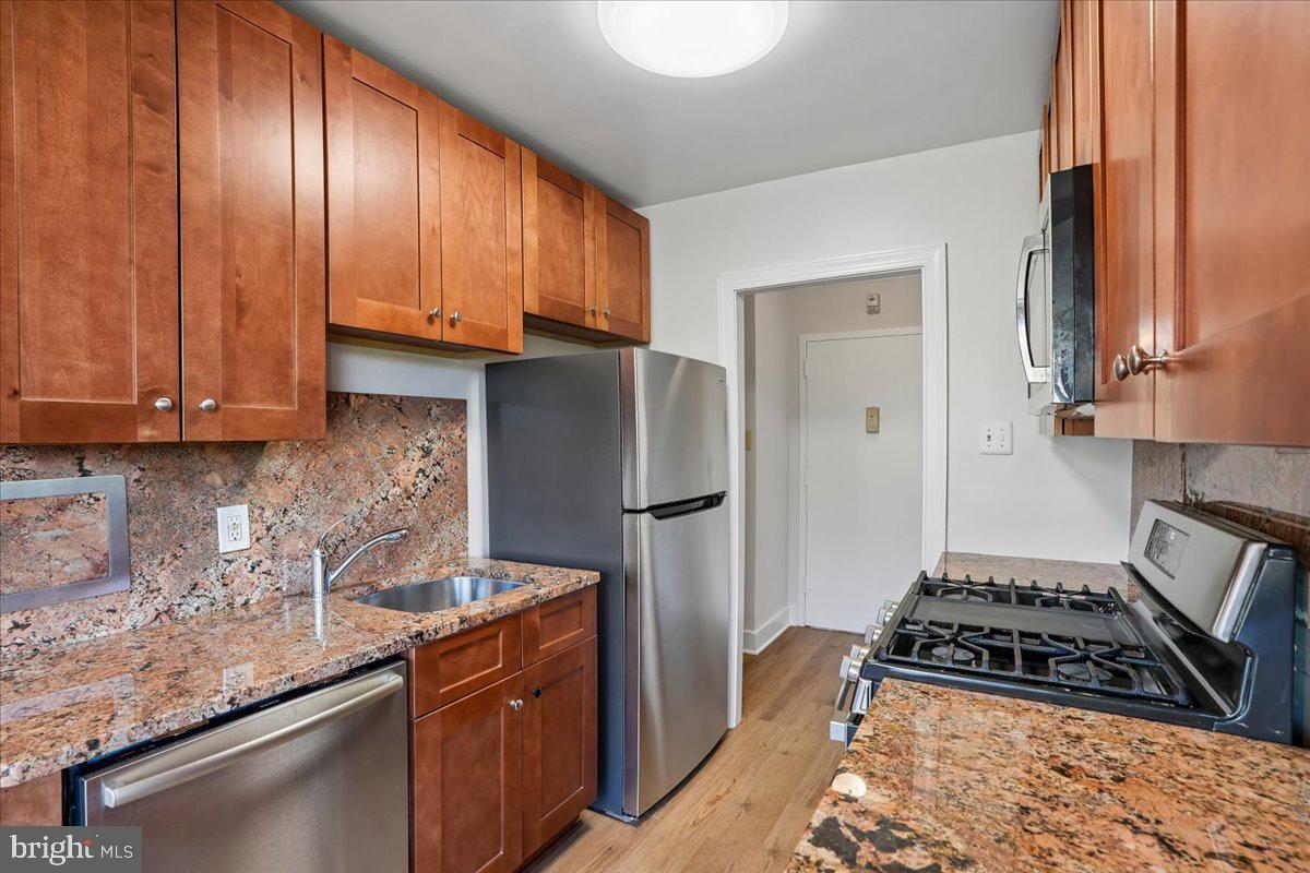 4000 Tunlaw Road Northwest, Unit 1003 Washington, DC 20007 - Photo 9 of 25 Modern kitchen with rich wood tones.